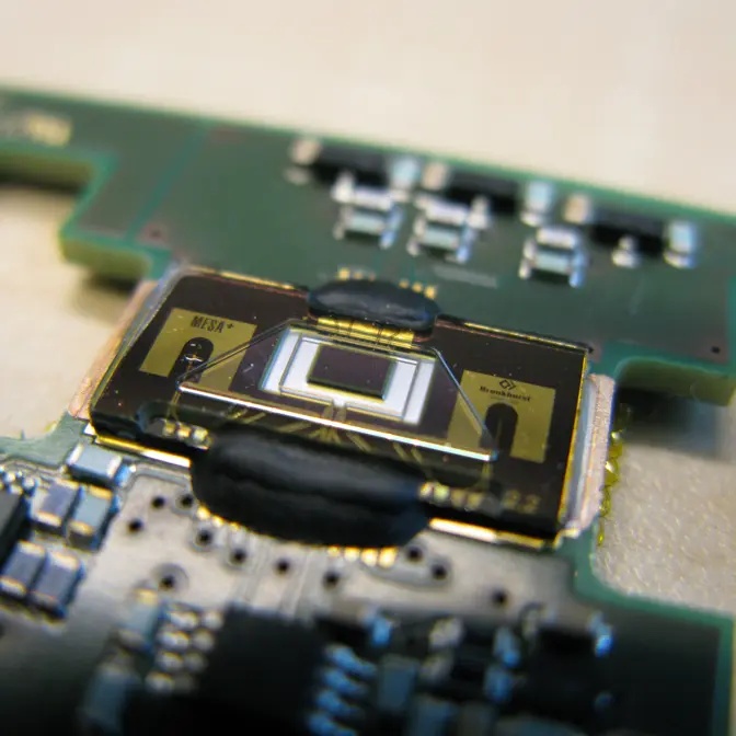 Close-up of a MEMS-based thermal flow sensor chip on a circuit board